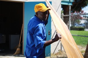 Photo by Alex Torres. Plant Manager Allen Ford cleans  out a shed as part of his duties to clean up the school.