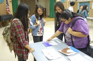 (From left to right) Juniors Jean Blas and Jamie Manzano and seniors  Ariana Hardwick-Jones and  Kassandra Alvarenga discuss the various types of artwork. Photo by  Jake Dobbs.