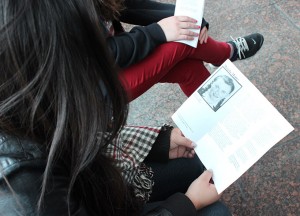 Students on the Museum of Tolerance field trip read booklets about people who experienced the Holocaust. Photo by Hailey Pohevitz.