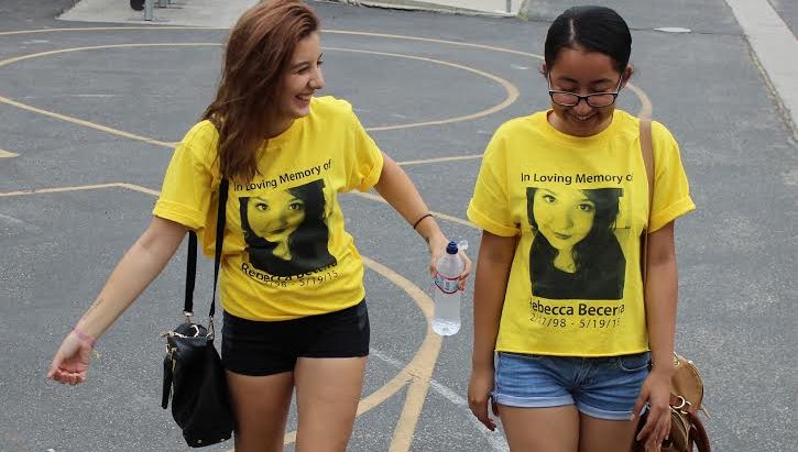 Seniors Valentina  Comar and Sindy Saravia  walk beside each other clad in their Rebecca Becerra shirts in remembrance of her. Bacerra committed suicide last year  in May.  Students were deeply impacted by her death and adorn themselves in yellow ribbons to fight teen suicide.   