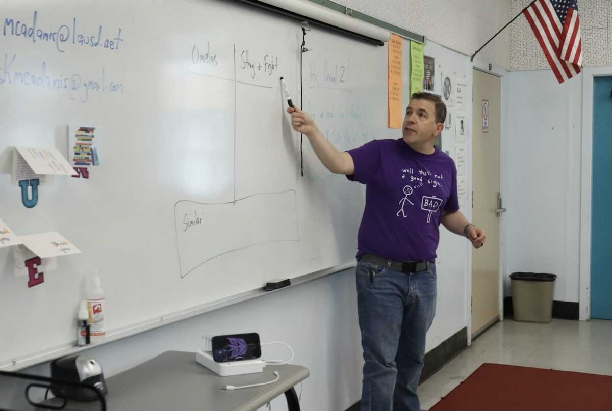 English teacher Christopher McAdamis, who will be leaving the school, teaches his 10th grade English class how to write compare-and-contrast essays on May 16.