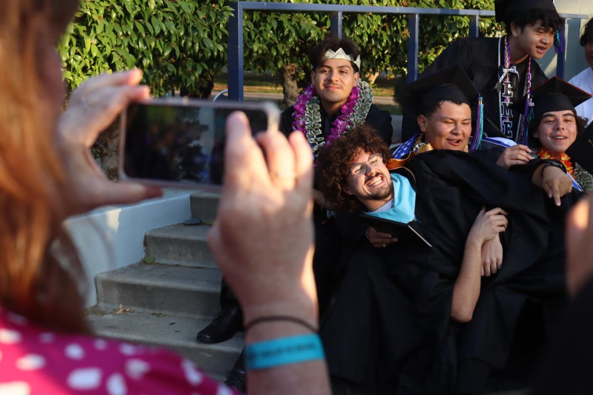 Math and Portuguese teacher Gonçalo Sousa is held up by seniors after the graduation ceremony on June 11. 