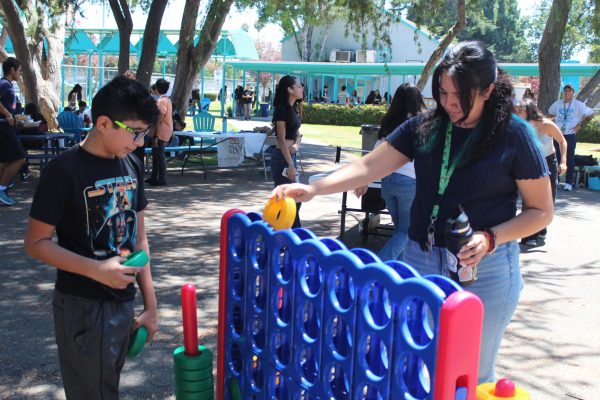 Sophomore Giancarlo Valdez and English teacher Valerie Quiroga play a game of Connect 4 on Aug. 16.