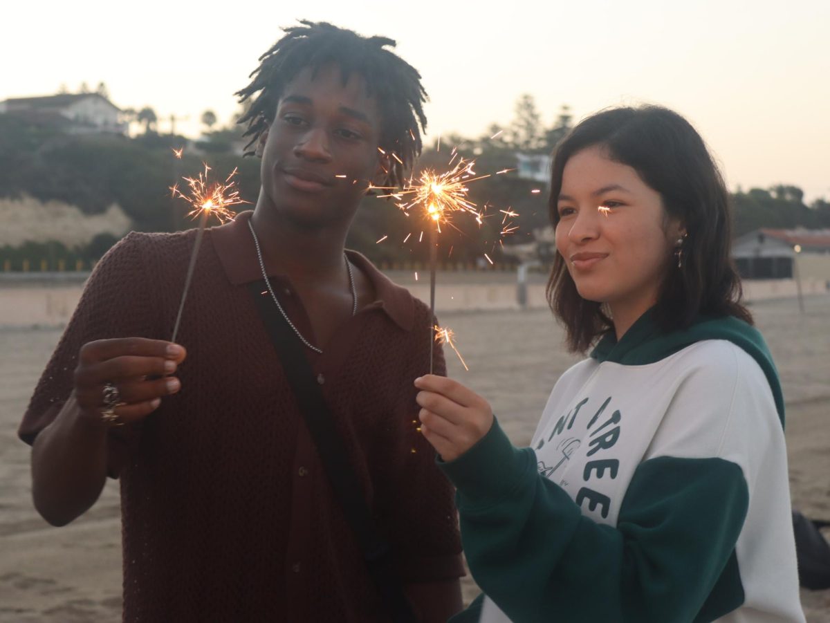 Seniors Zion Waddell and Jeremy Melendez wave around sparklers during Senior Sunrise on Aug. 31. Senior Sunrise is one of the many events seniors will have to bond with their classmates before they graduate.