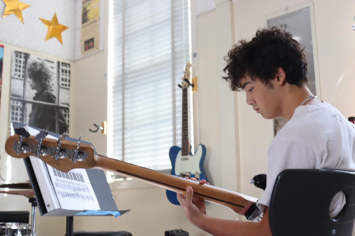 Junior Mose Judge-Glasscock plays the bass in music teacher Wes Hambright's classroom during nutrition on Sept. 13.