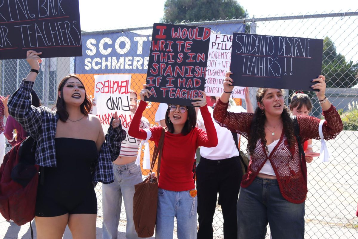 Junior Delilha Trujillo, senior Genesis Cuellar-Figueroa and senior Leeron Nakash protest for the reinstatement of music teacher Wes Hambright and Spanish teacher Glenda Hurtado. The protest took place at the Los Angeles Unified School District's Region North office on Sept. 23. The three helped organize the walkout, which drew about 150 attendees. 