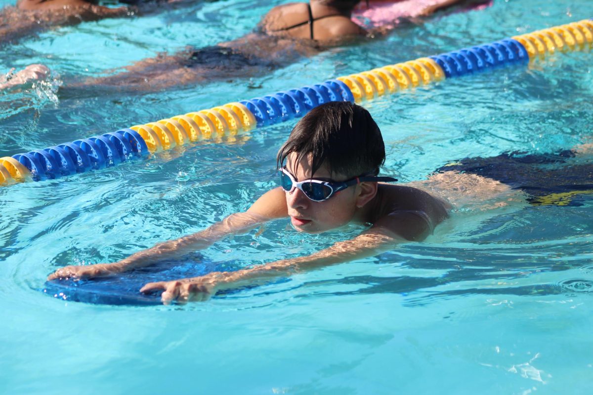 Senior Diego Vera Suarez swims during practice at Birmingham Community Charter High School on March 3. Athletes swam using a kickboard after practicing their freestyle swimming back and forth across the pool. 