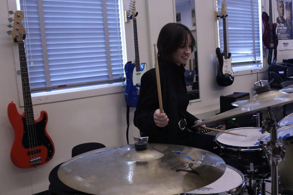 Senior Lilli Miscione plays "Something" by The Beatles on the drums during after school rehearsals on Jan. 27.  Music rehearsals are held for students participating in the music department's Valentine’s Day and Spring Concert later this school year.