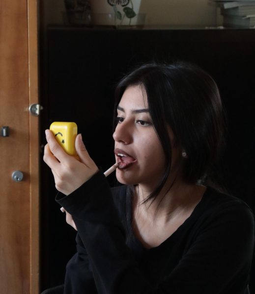 Sophomore Lexi Lopez applies lip liner during Cosmetology Club on Nov. 21 in Room 15. Students in the club can gain tips from one another and express their creativity through cosmetics. 