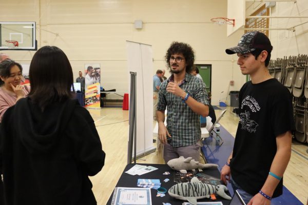 Math and Portuguese teacher Gonçalo Fino De Sousa and Pearl Ambassador Mateo Zazueta discuss what Daniel Pearl Magnet High School (DPMHS) has to offer for future high school students. During events such as Magnet Night, student ambassadors and teachers come together to promote the school, especially to increase low enrollment.