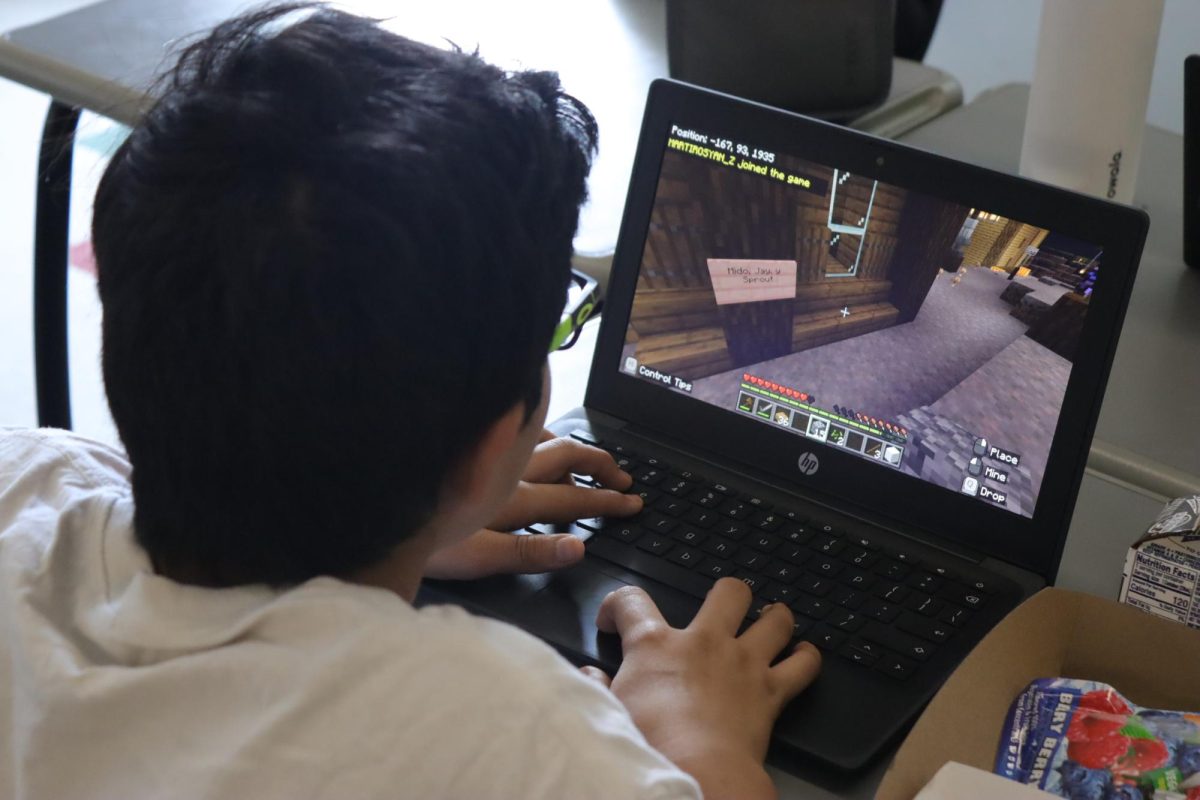 Sophomore Giancarlo Valdez plays Minecraft in a Minecraft Club meeting on Oct. 21. The club meets every Monday in Room 14. Students play “Minecraft Education Edition” on their devices and learn building teqniques from other club members.