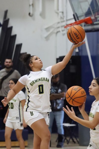 Sophomore Ava Weinstein sharpens her underhand shooting skills during half-time on Jan. 17. Weinstein prepares for the girls' junior varsity team's future games. 