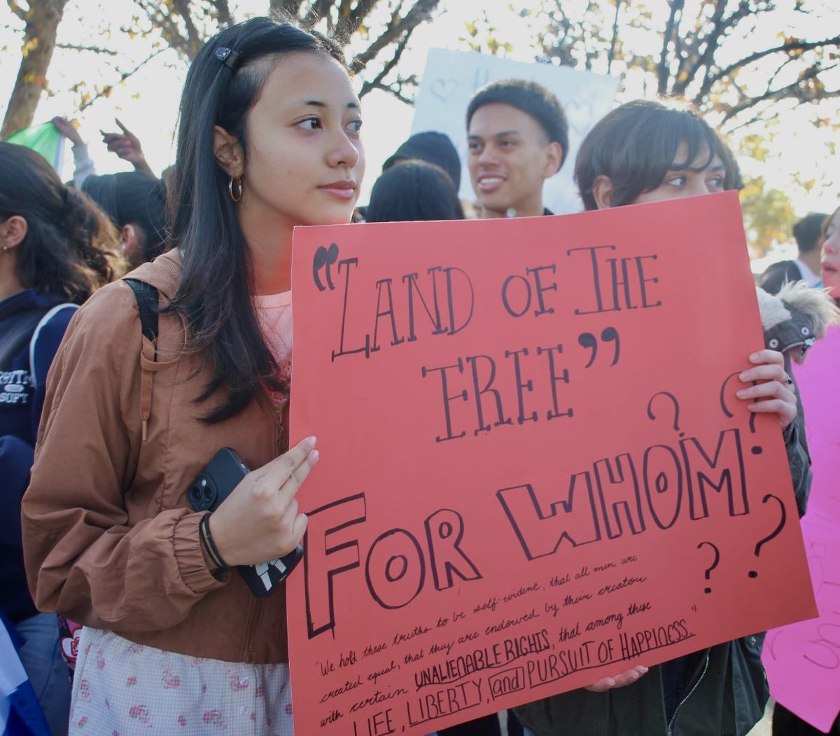 Students hold a sign criticizing the lack of freedom given to immigrants on Feb. 10.