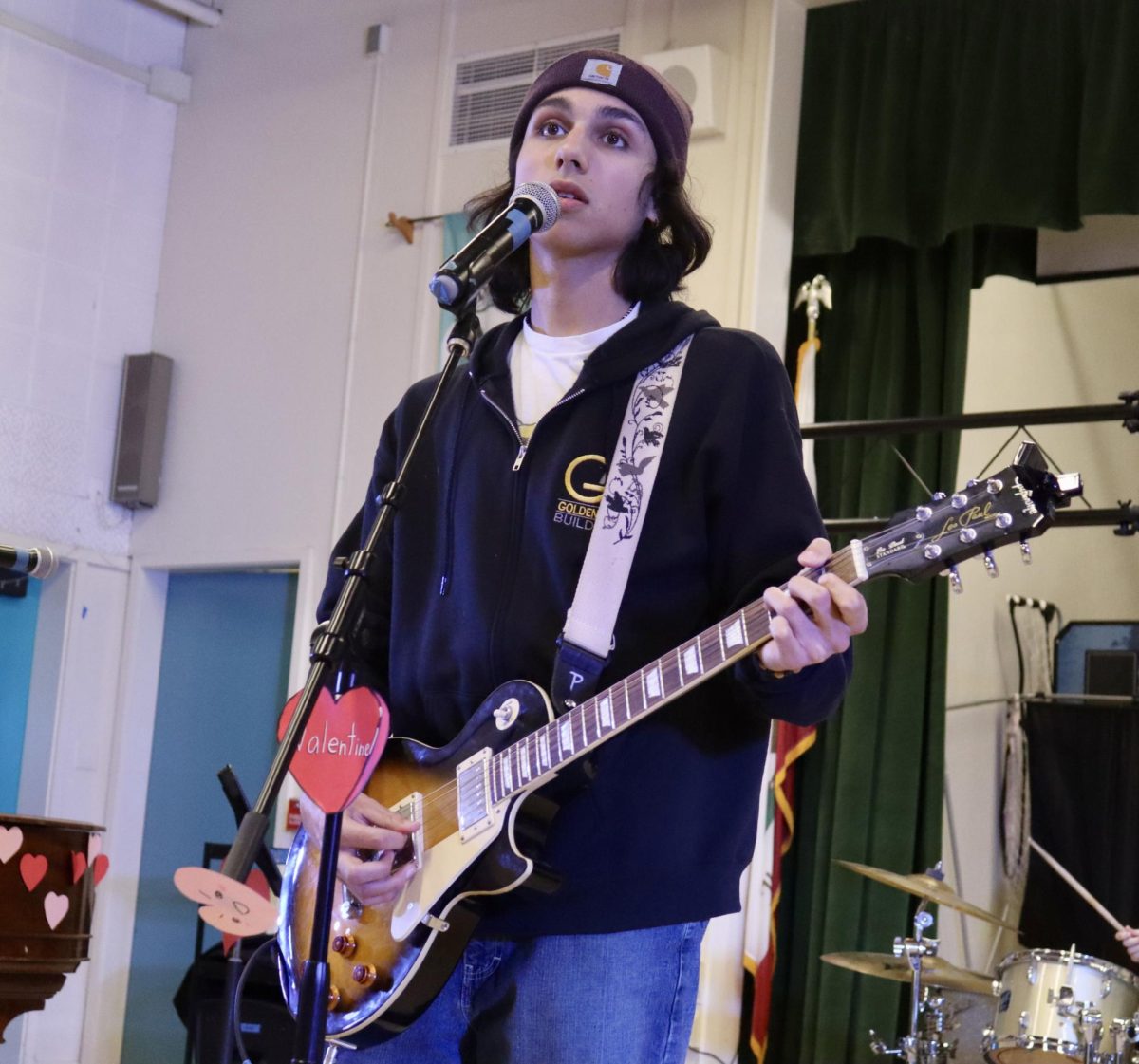 Junior Sebastian Olfatmanesh sings “Something” by the Beatles while playing the guitar on Feb. 11. Students rehearsed for the Valentine’s Day concert, which will be held on Feb. 13 in the MPR.