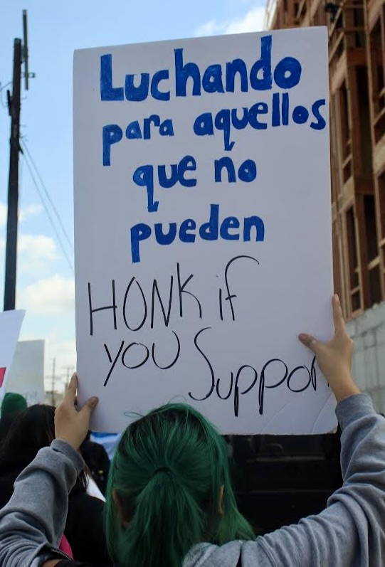 A student holds a sign asking others to fight for those who cannot on Feb. 10.