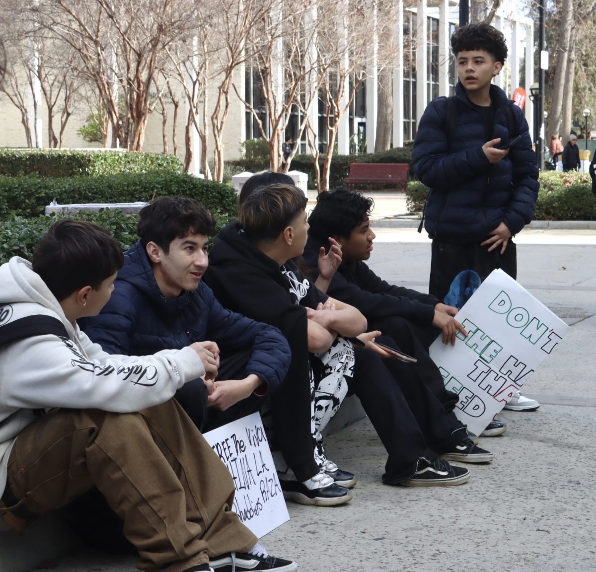 Students from Reseda Charter High School sit outside the Van Nuys West Courthouse after walking for about two hours to protest on Feb. 10.