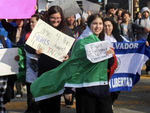 Students protest with signs and flags as they walk between Victory Blvd. and Balboa Blvd. on Feb. 10.