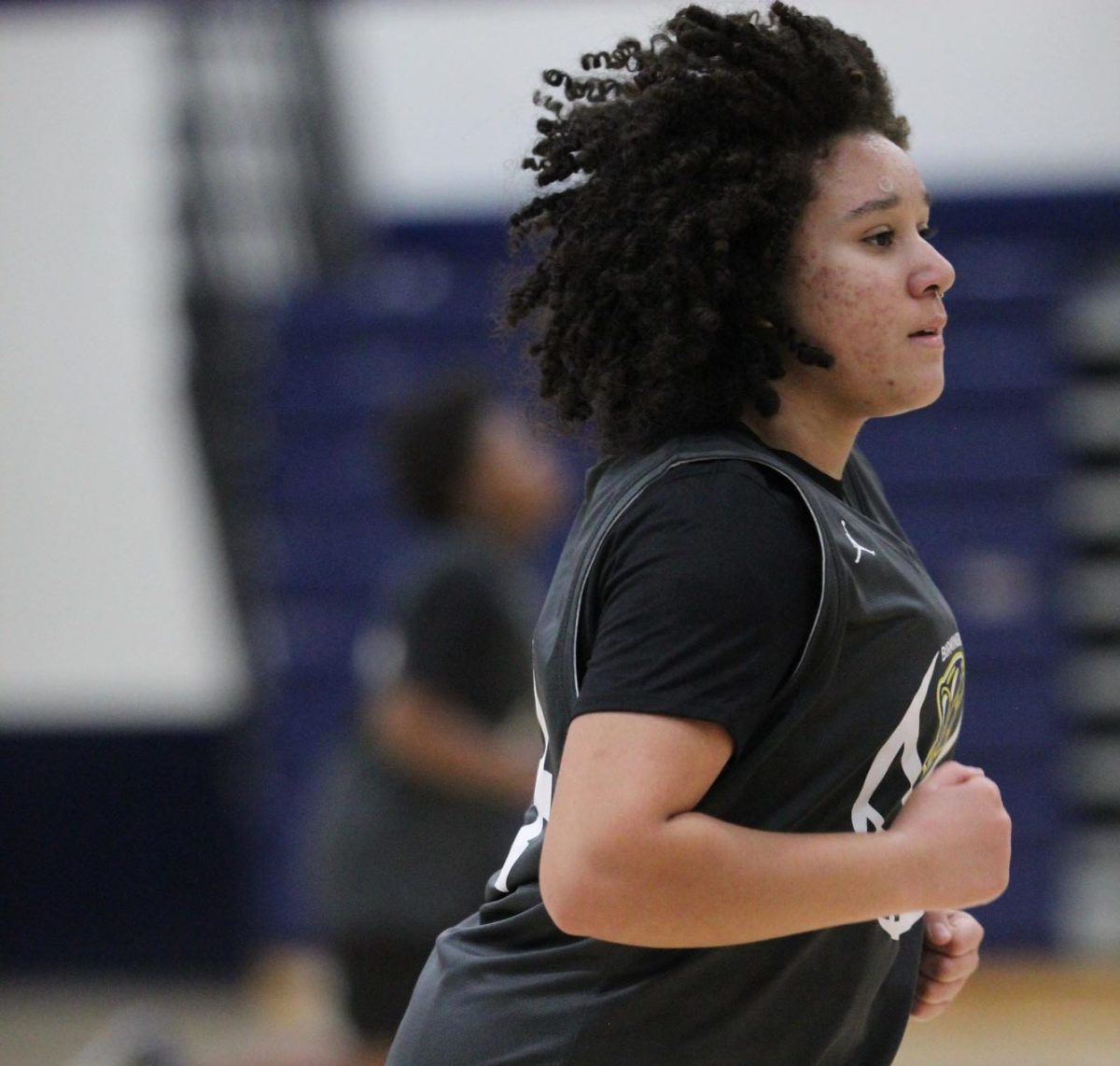 Sophomore Andrea Arosemena  sprints during basketball practice at Birmingham Community Charter High School on Jan. 30. After warming up, athletes ran back and forth across the gym as punishment for an altercation with another team. 