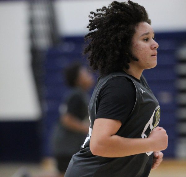 Sophomore Andrea Arosemena  sprints during basketball practice at Birmingham Community Charter High School on Jan. 30. After warming up, athletes ran back and forth across the gym as punishment for an altercation with another team. 