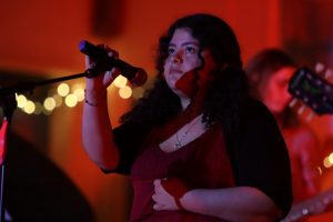 Junior Nemesi Morales performs the song "Anything Anything" by Dramarama during the Valentine's Day concert on Feb. 13.