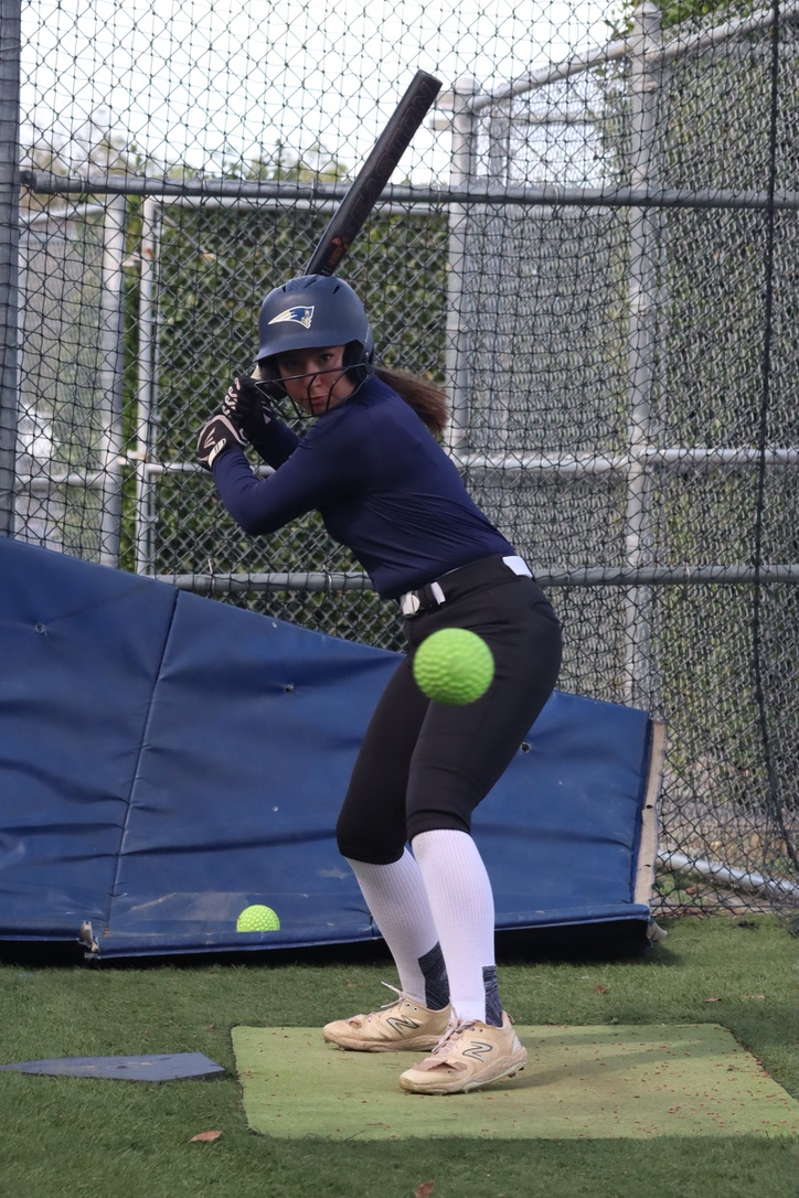 Sophomore Emma Bullock practices her swing in the batting cages on April 1. Bullock plays on the varsity softball team for Birmingham Community Charter High School and wishes to play for the next two years of her high school career.