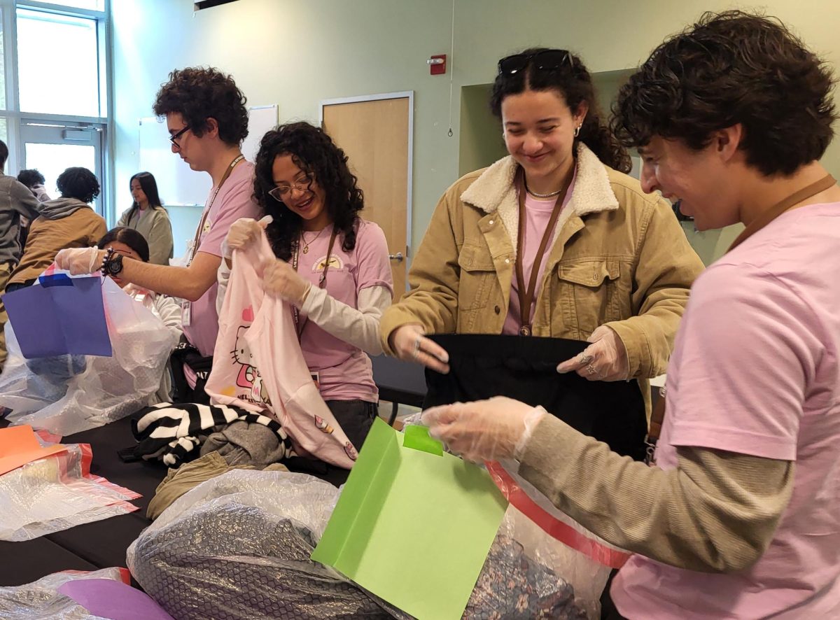Teen Council for Conservation members Daniel Maya, Allison Gonzalez, Addi Komwiser and Isaac Herrera sort through clothing. As part of the "Mindful Choices" workshop  by Circular Fashion L.A., participants sorted through clothes and grouped them by quality, then planned ways for the clothes to be reused. The workshop took place at the Los Angeles Zoo's Conservation Symposium on March 15. 